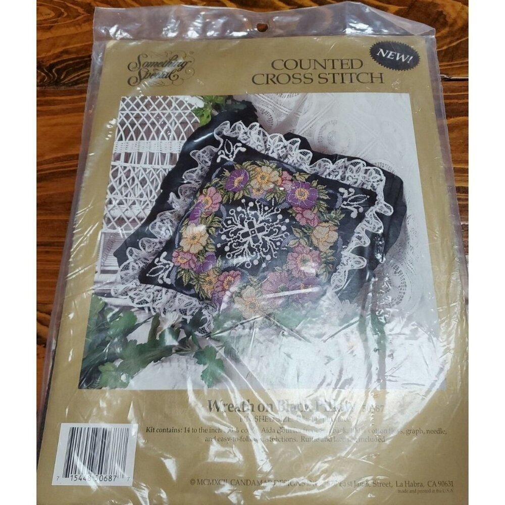 Something Special Counted Cross Stitch Kit #50687 wreath on black pillow.